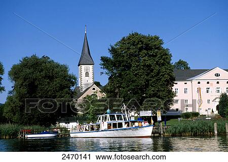 Stock Image - Church at waterfront, Carinthia, Austria . Fotosearch