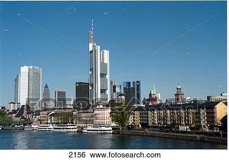 Stock Photograph - City skyline against blue sky, River Main, Frankfurt, Germany . Fotosearch