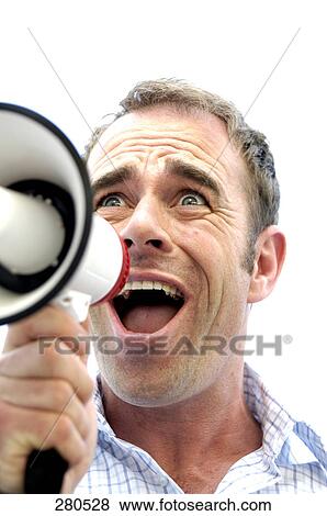 Stock Photo - Close-up of a mature man shouting into megaphone . Fotosearch