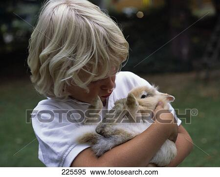 Close-up of boy carrying rabbit View Large Photo Image Stock Photography - Close-up of boy carrying rabbit . Fotosearch
