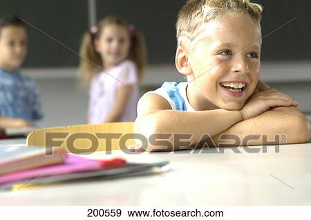 Stock Photo - Close-up of boy smiling in classroom . Fotosearch