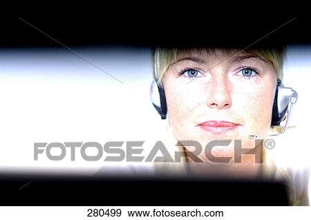 Close-up of businesswoman wearing headset View Large Photo Image Stock Photo - Close-up of businesswoman wearing headset . Fotosearch