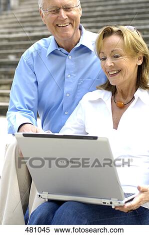 Stock Photography - Close-up of couple looking at laptop . Fotosearch