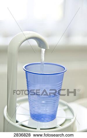 Close-up of disposable cup under water tap in dentist office View Large Photo Image Stock Photo - Close-up of disposable cup under water tap in dentist office . Fotosearch
