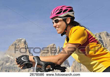 Close-up of female mountain biker smiling, Dolomites, Italy View Large Photo Image Stock Photograph - Close-up of female mountain biker smiling, Dolomites, Italy . Fotosearch
