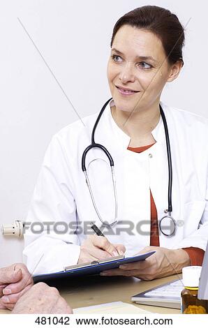 Stock Image - Close-up of female writing on clipboard . Fotosearch