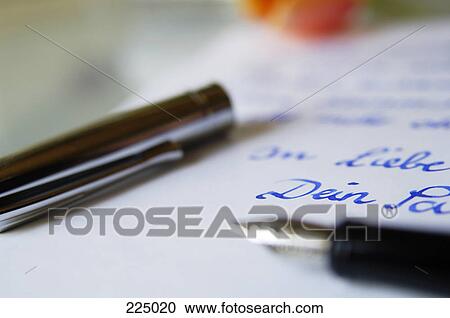Stock Image - Close-up of fountain pen on love letter . Fotosearch