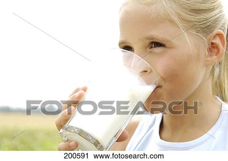 Close-up of girl drinking milk View Large Photo Image Stock Image - Close-up of girl drinking milk . Fotosearch