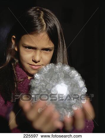 Close-up of girl holding crystal View Large Photo Image Stock Photo - Close-up of girl holding crystal . Fotosearch