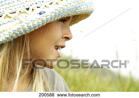 Close-up of girl smiling in field View Large Photo Image Stock Photo - Close-up of girl smiling in field . Fotosearch