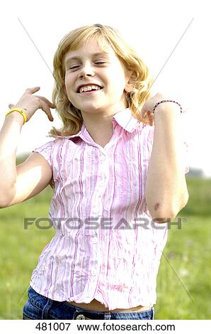 Stock Photo - Close-up of girl smiling in field . Fotosearch