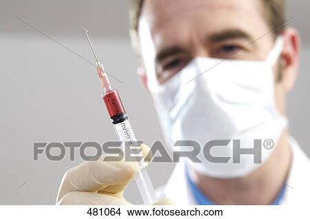 Picture - Close-up of male surgeon holding syringe . Fotosearch