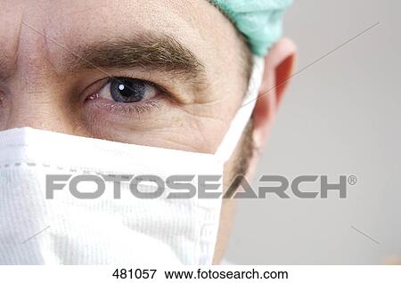 Stock Photo - Close-up of male surgeon wearing mask . Fotosearch