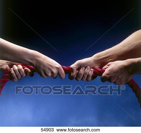 Close-up of man and woman playing tug of war View Large Photo Image Stock Image - Close-up of man and woman playing tug of war . Fotosearch