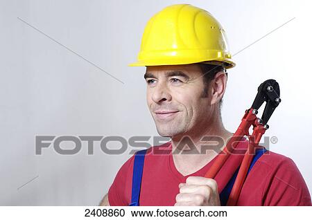 Close-up of man holding pliers View Large Photo Image Stock Image - Close-up of man holding pliers . Fotosearch