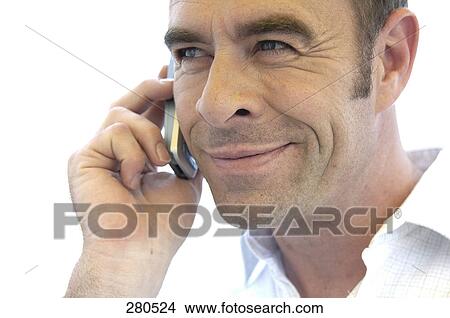 Close-up of mature man talking on mobile phone View Large Photo Image Picture - Close-up of mature man talking on mobile phone . Fotosearch