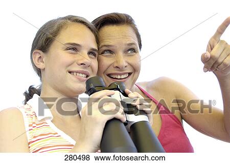Stock Photo - Close-up of mature woman and her daughter smiling . Fotosearch