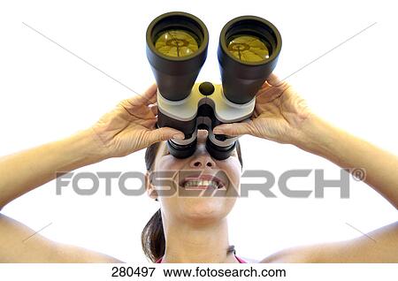 Stock Photo - Close-up of mature woman looking through binoculars and smiling . Fotosearch