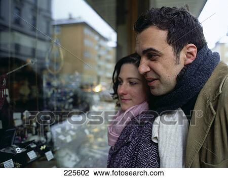 Close-up of mid adult couple doing window shopping View Large Photo Image Stock Image - Close-up of mid adult couple doing window shopping . Fotosearch