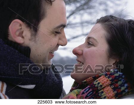 Stock Image - Close-up of mid adult couple romancing . Fotosearch