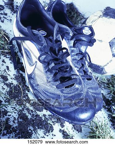 Stock Photo - Close-up of pair of soccer shoes and ball . Fotosearch