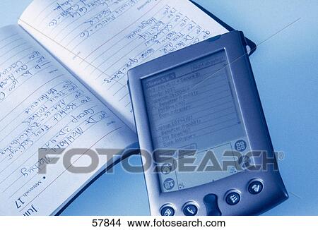 Picture - Close-up of personal data assistant and diary . Fotosearch