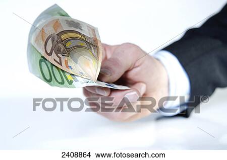 Close-up of person's hand offering European Union Euro notes View Large Photo Image Picture - Close-up of person's hand offering European Union Euro notes . Fotosearch