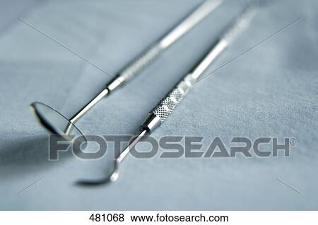 Stock Photo - Close-up of plaque remover and angled mirror . Fotosearch
