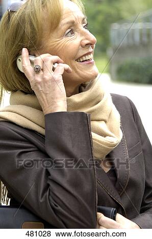 Close-up of senior woman talking on mobile phone View Large Photo Image Stock Photo - Close-up of senior woman talking on mobile phone . Fotosearch