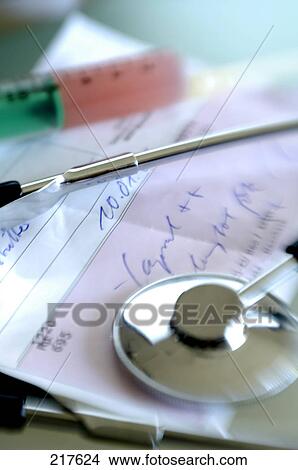 Picture - Close-up of stethoscope and syringe on prescription . Fotosearch