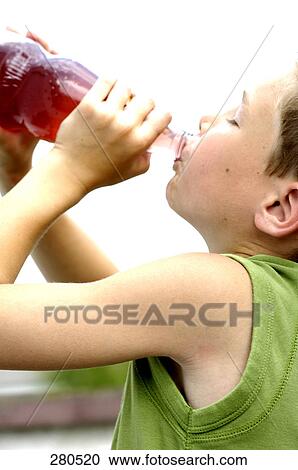Close-up of teenage boy drinking juice View Large Photo Image Stock Image - Close-up of teenage boy drinking juice . Fotosearch