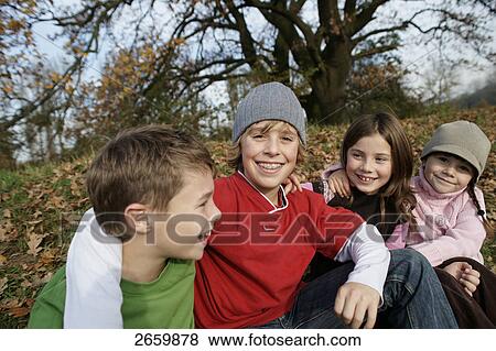 Close-up of two boys and two girls smiling View Large Photo Image Stock Photo - Close-up of two boys and two girls smiling . Fotosearch