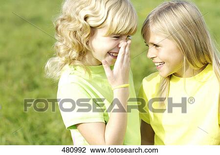 Stock Image - Close-up of two girls smiling . Fotosearch