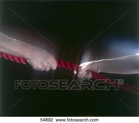Close-up of woman in tug-of-war with man View Large Photo Image Stock Image - Close-up of woman in tug-of-war with man . Fotosearch