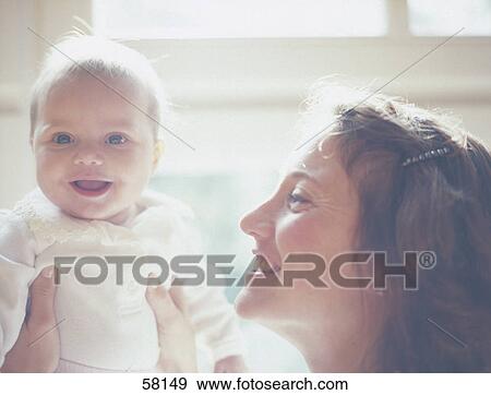 Stock Photo - Close-up of woman playing with her son . Fotosearch