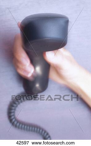 Stock Photo - Close-up of woman's hand holding telephone receiver . Fotosearch