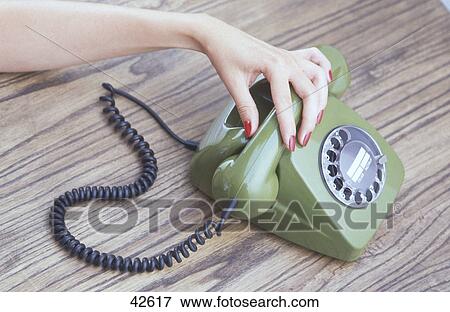 Close-up of woman's hand using antique rotary phone View Large Photo Image Stock Photo - Close-up of woman's hand using antique rotary phone . Fotosearch