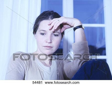 Stock Image - Close-up of young woman looking sad . Fotosearch