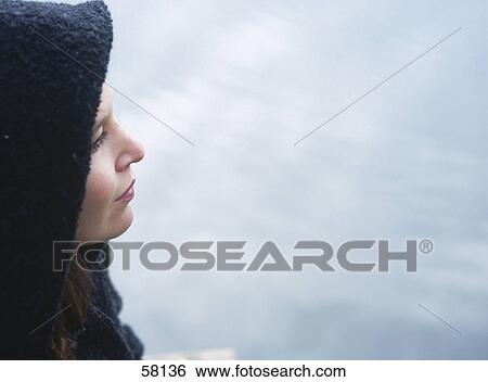Stock Photograph - Close-up of young woman thinking . Fotosearch