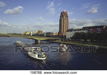 Stock Photo - Container ship in river, Main River, Floesserbruecke Bridge, Frankfurt, Germany . Fotosearch
