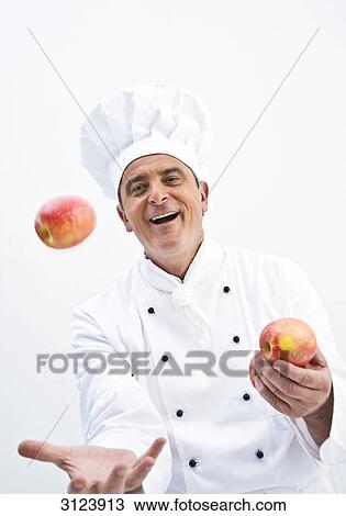 Cook juggling with two apples, front view View Large Photo Image Stock Image - Cook juggling with two apples, front view . Fotosearch