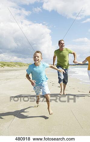 Couple running with their son on beach, Egersund, Stavanger, Norway View Large Photo Image Stock Photo - Couple running with their son on beach, Egersund, Stavanger, Norway . Fotosearch