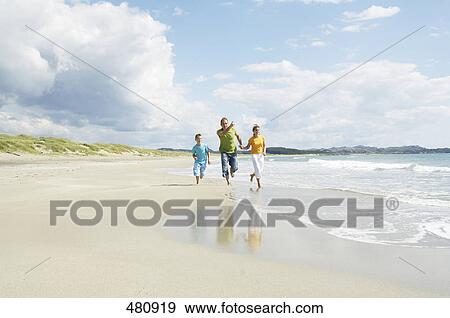 Couple running with their son on beach, Egersund, Stavanger, Norway View Large Photo Image Stock Photo - Couple running with their son on beach, Egersund, Stavanger, Norway . Fotosearch