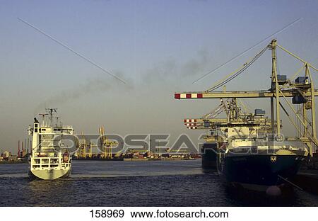 Crane and container ship at port, Elbe River, Hamburg, Germany View Large Photo Image Stock Photo - Crane and container ship at port, Elbe River, Hamburg, Germany . Fotosearch
