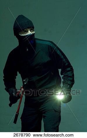 Stock Image - criminal person planning a robbery, portrait . Fotosearch
