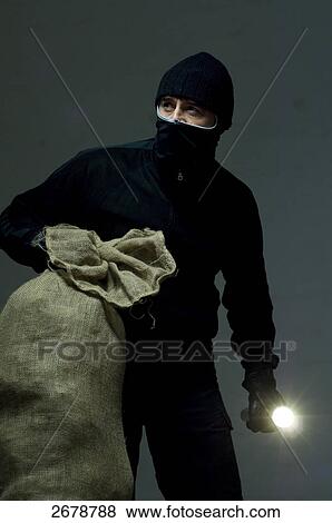 Stock Photo - criminal person planning a robbery, portrait . Fotosearch