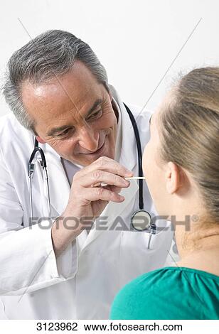 Doctor examining a female patient View Large Photo Image Stock Image - Doctor examining a female patient . Fotosearch