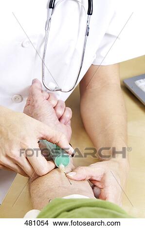 Doctor giving injection to patient View Large Photo Image Picture - Doctor giving injection to patient . Fotosearch