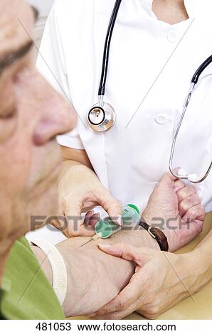 Stock Image - Doctor giving injection to patient . Fotosearch