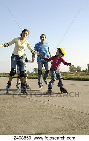 Family inline skating on road View Large Photo Image Stock Image - Family inline skating on road . Fotosearch